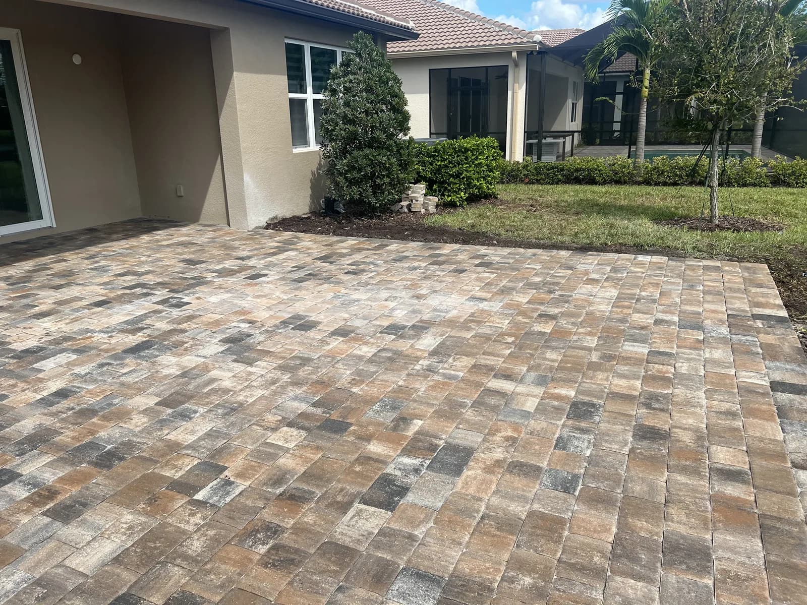 Multi-tone brick paver patio in a residential courtyard