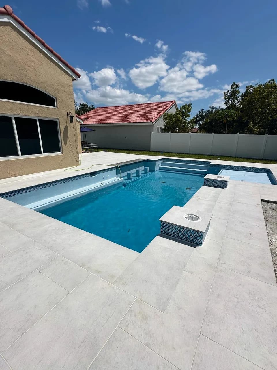 Lucerna Bianco porcelain pavers installed on a Florida pool deck by EC Paver Solutions