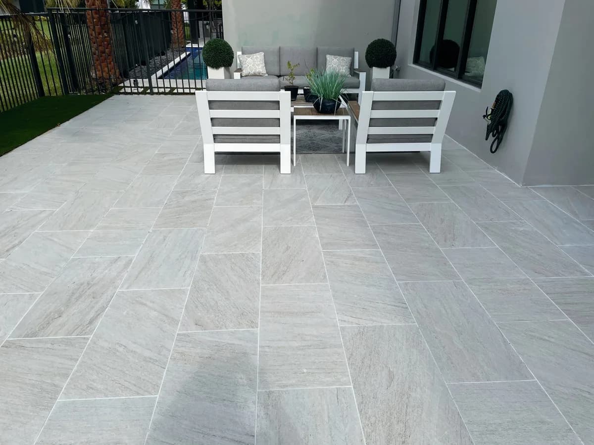 Quartz Bianco porcelain pavers installed on a Florida outdoor living space by EC Paver Solutions