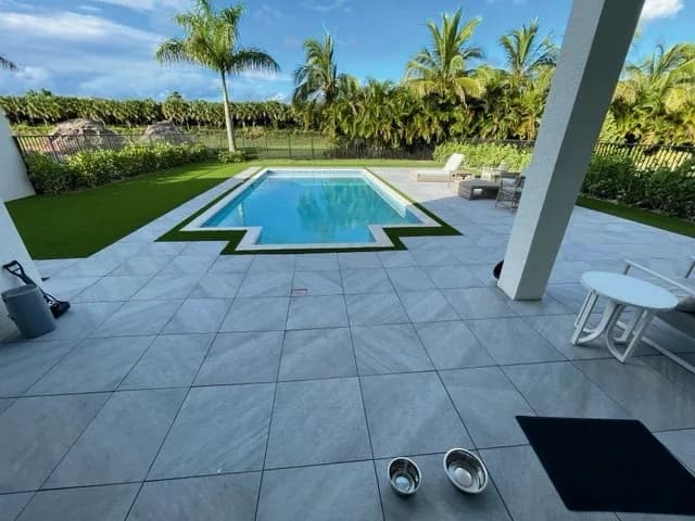 Quartz Griss porcelain pavers installed on a Florida outdoor living space by EC Paver Solutions