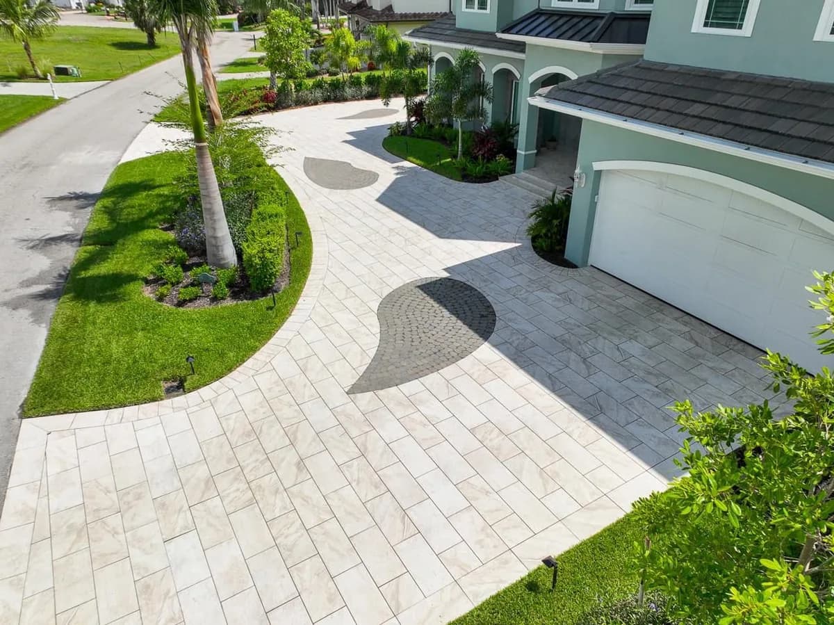 A driveway is not a patio: 8 inches of compacted limestone base, placed and compacted in lifts.