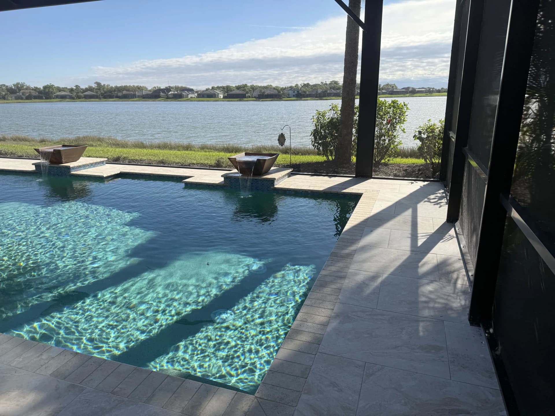 Natural stone pool deck on a waterfront property with open bay views