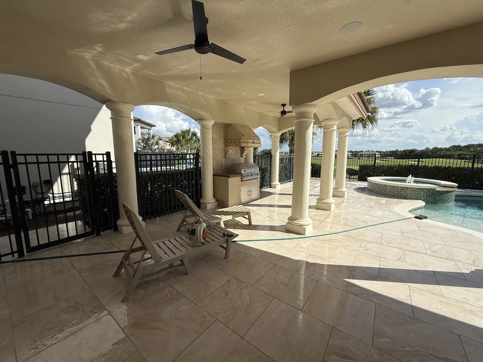 Covered outdoor living area with paver patio and golf course views