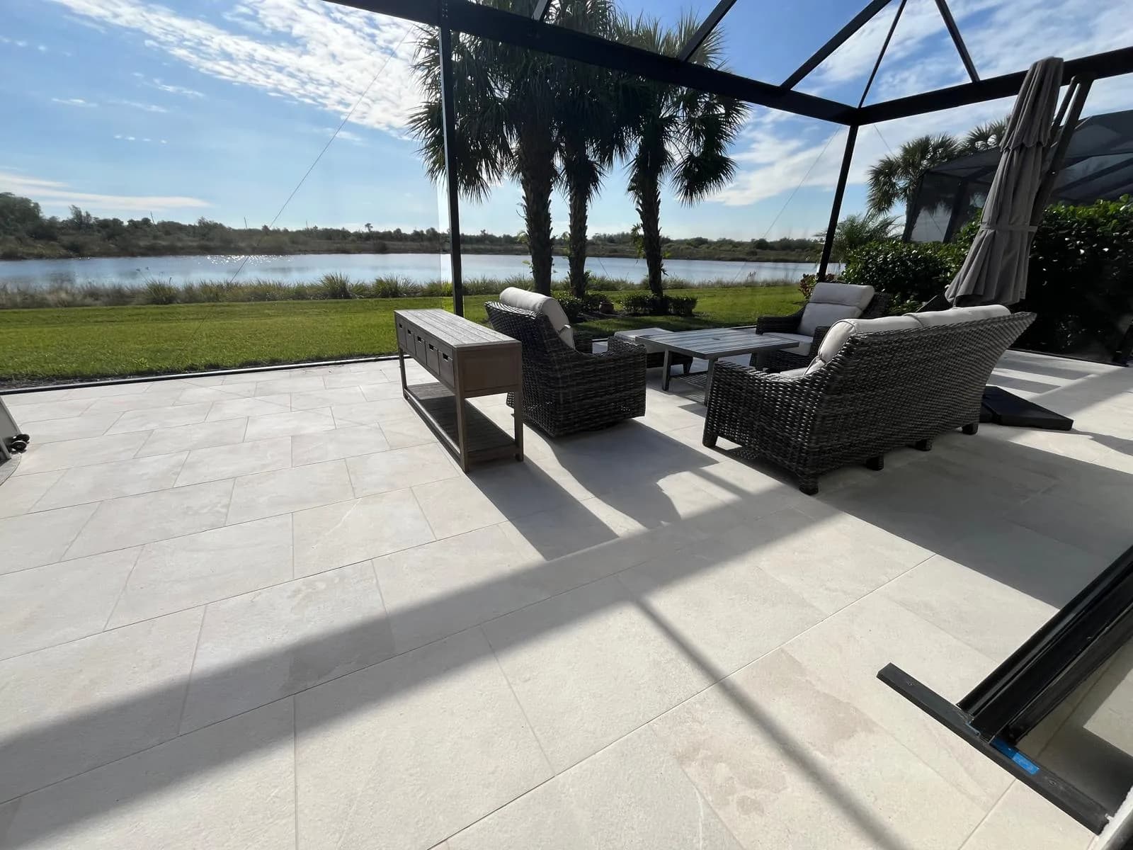 Outdoor seating area on a paver patio overlooking a lake in Florida