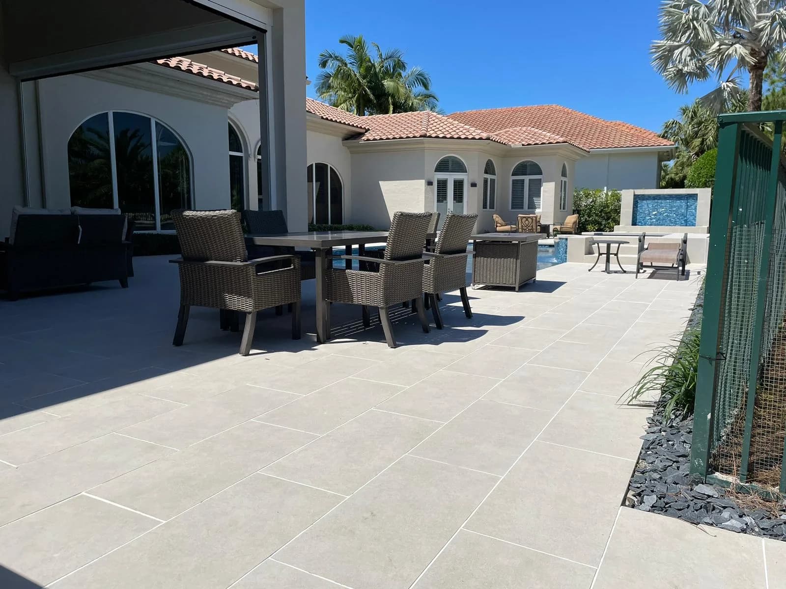 Paver patio with outdoor dining set at a Mediterranean-style Florida home