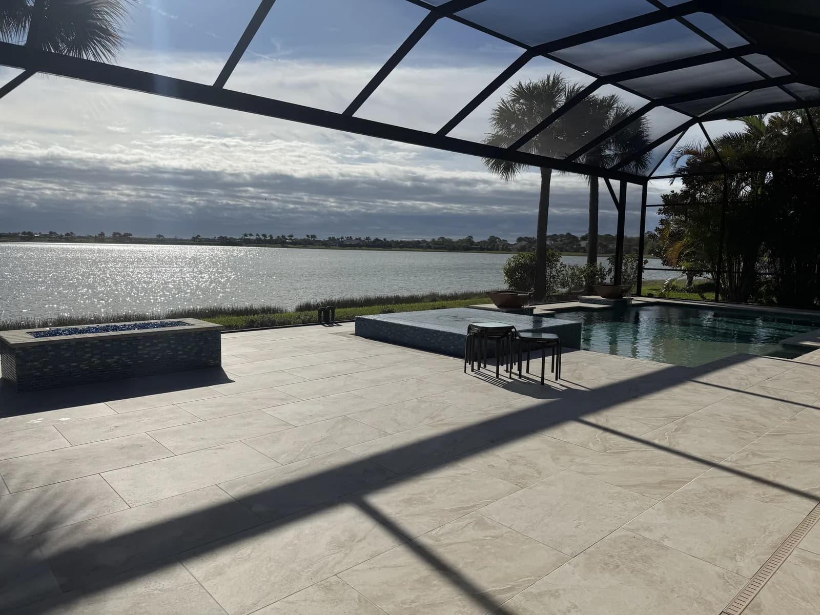 Wide screened lanai with paver flooring and open lake views