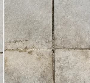 Standing water staining and organic growth along porcelain paver joints from poor drainage