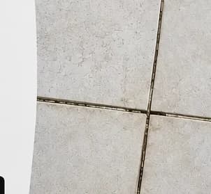 Porcelain pavers with inconsistent spacing and a joint closing to nothing