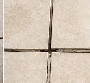 Misaligned porcelain pavers with one edge higher than the next, showing lippage