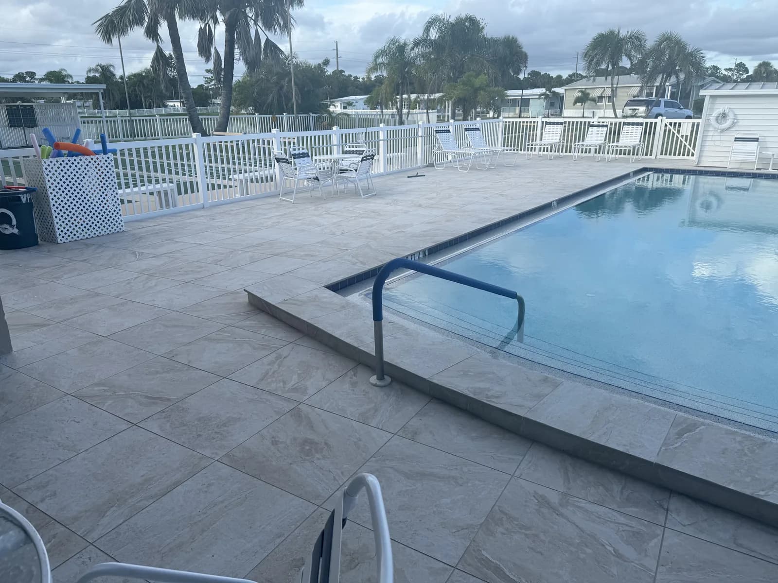 Travertine pool deck and spa with a private dock