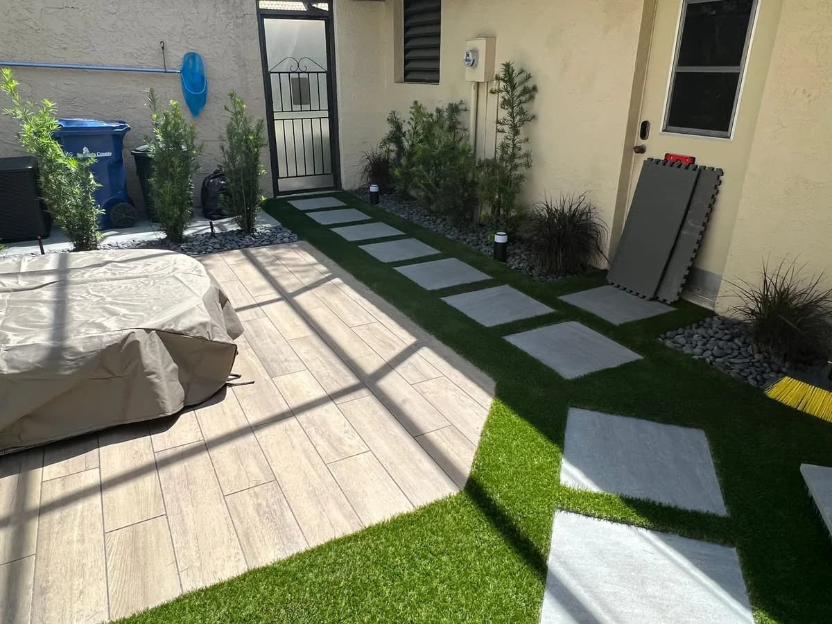 Pet spec: short pile, perforated backing, 8-inch draining base, antimicrobial infill + zeolite topdressing.