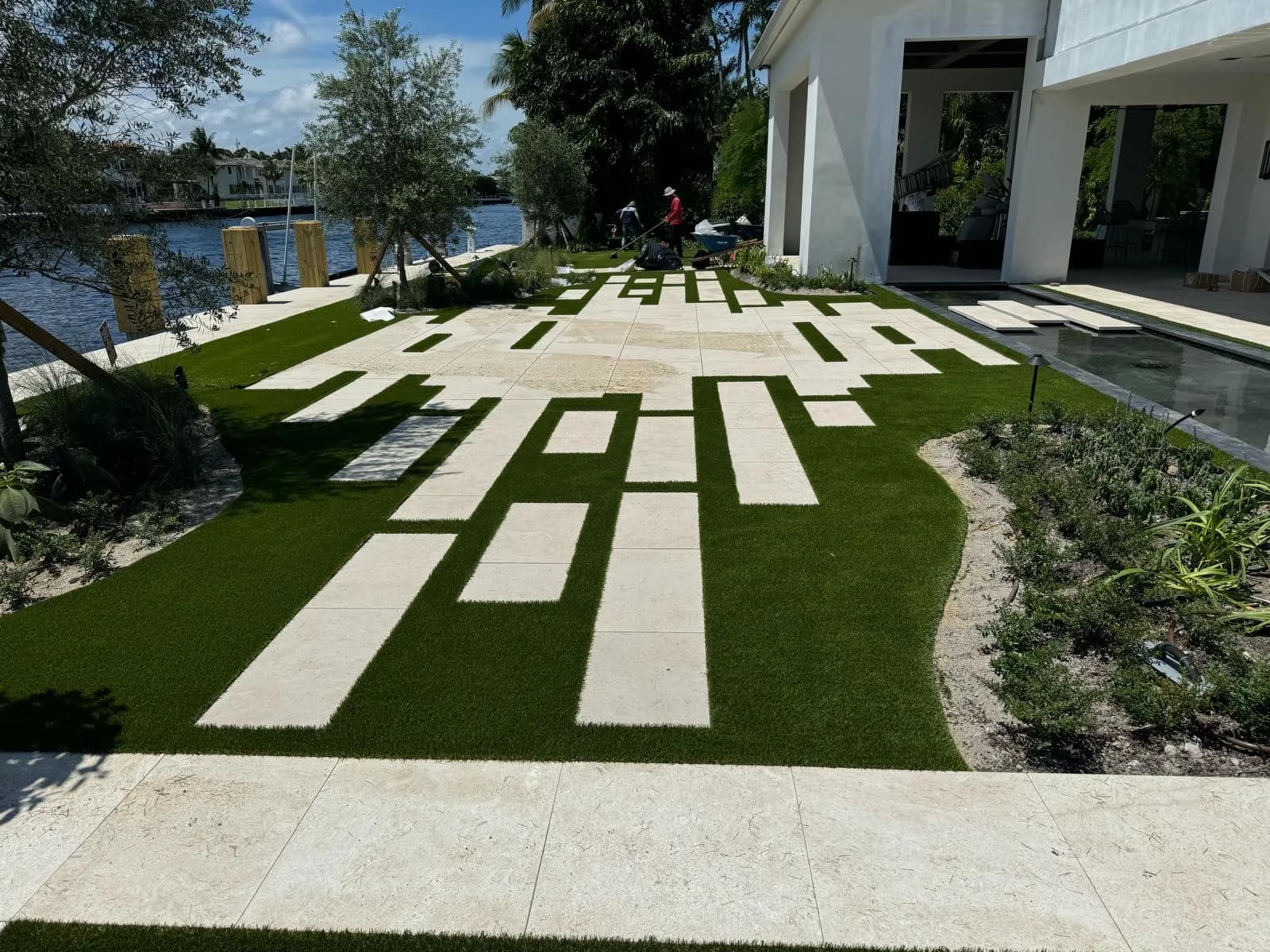 Paver stepping strips set in turf leading to a waterfront lawn